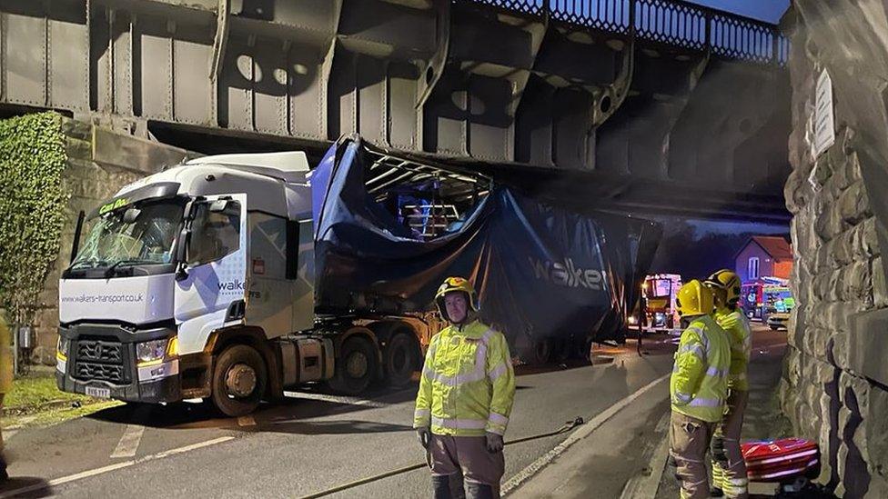 Officers with lorry under bridge