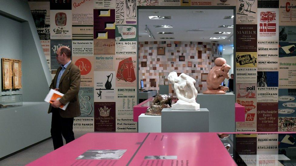 A visitor looks at artworks on display in the exhibition "Gurlitt: Status Report Nazi Art Theft and its Consequences" at the Art and Exhibition Hall of the Federal Republic of Germany (Bundeskunsthalle) in Bonn, Germany on 2 November 2017.