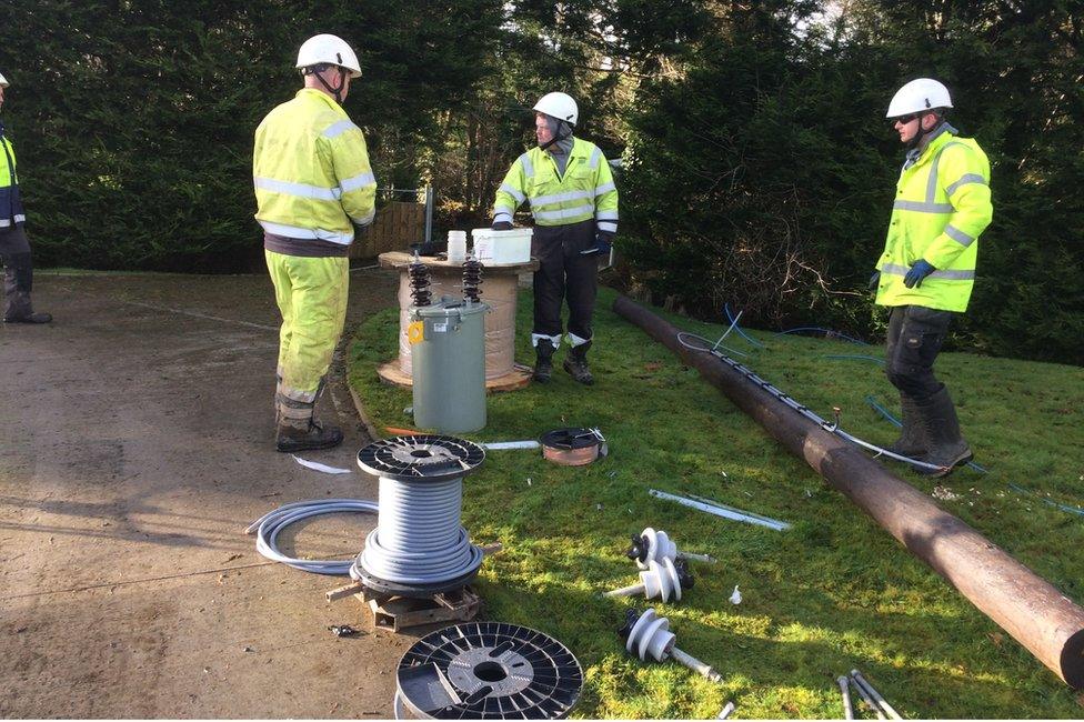 NIE Network crew fixs a power line outside Crossgar where a line of trees fell and smashed electric poles