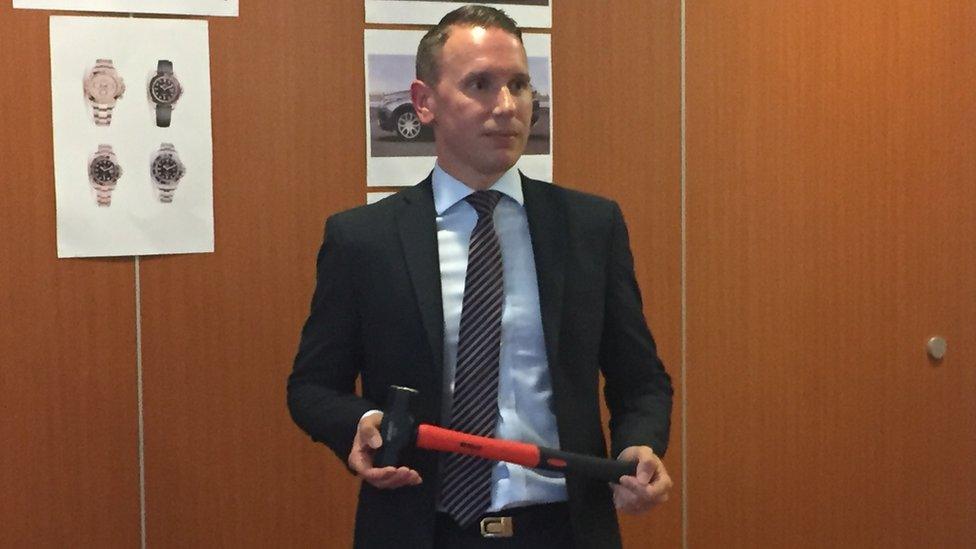 DCI Andy Patrick with a hammer similar to the one used in the raid