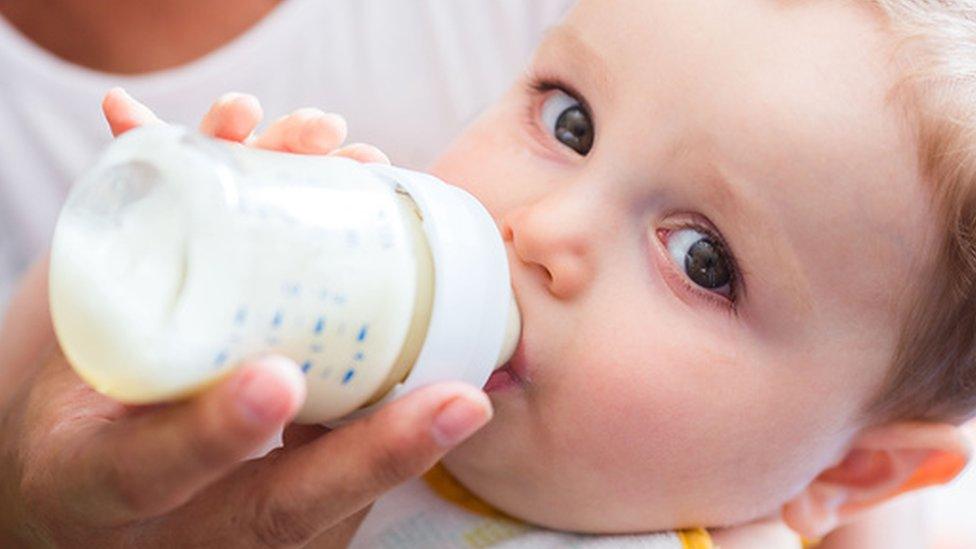 Baby feeding on formula