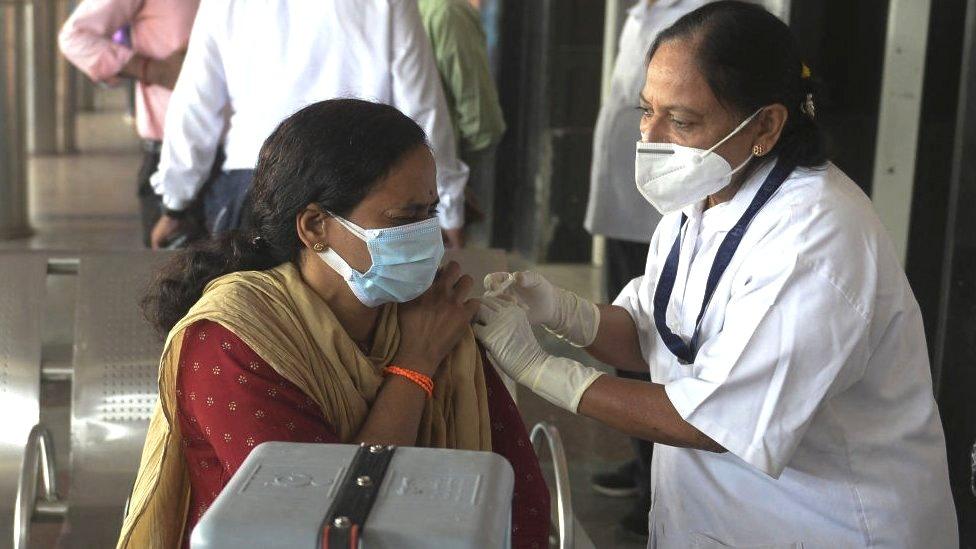 Woman gets a booster shot in Secunderabad, India