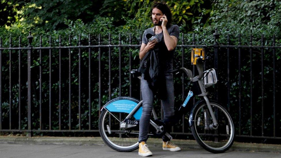 Russell Brand on bike after joining anti austerity protests on 21 June 2014