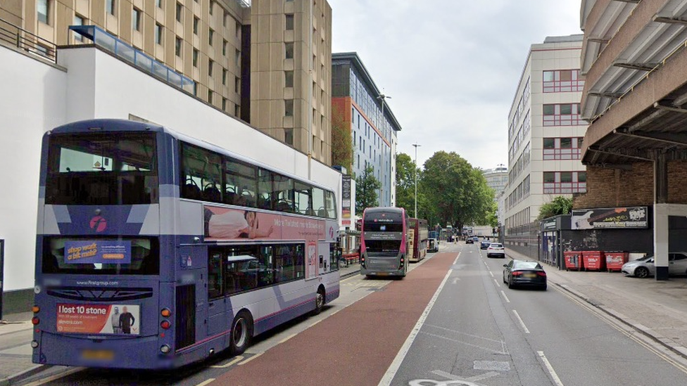 A bus moving through Bristol city centre