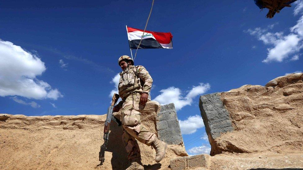 An Iraqi soldier holds a position on the frontline on the outskirts of Makhmur, about 280 km (175 miles) north of Baghdad