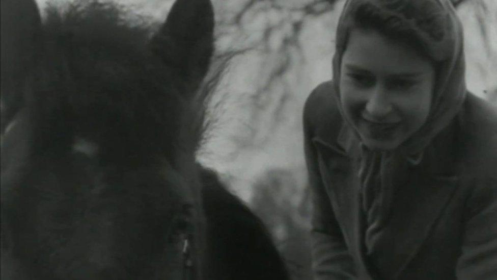 The Queen when she was younger with a horse