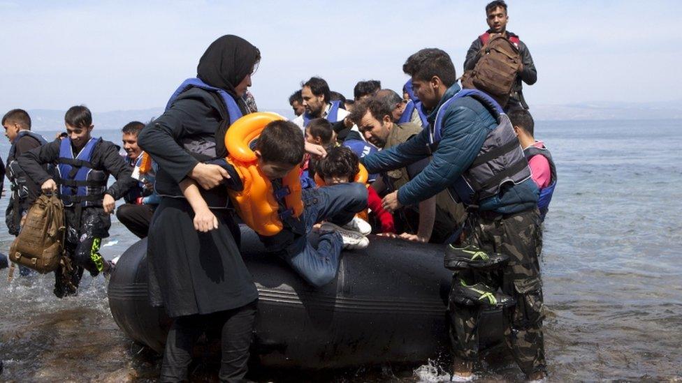 Afghan refugees arrive on a dinghy on the Greek island of Lesbos