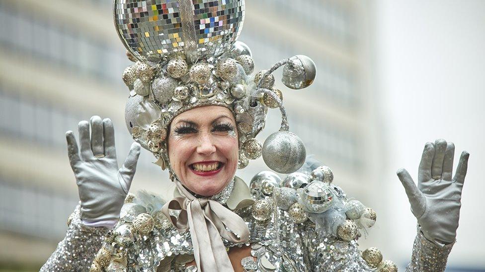 woman covered in silver baubles