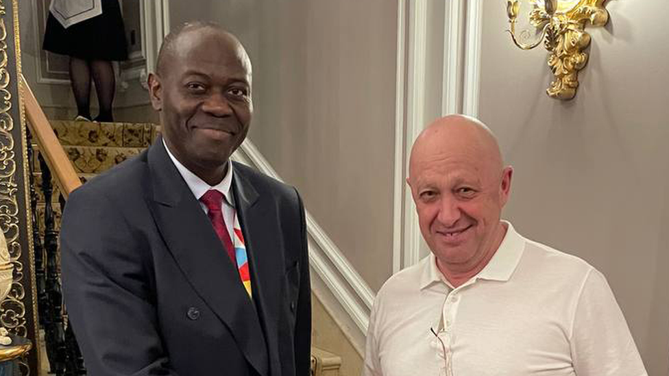 Ambassador Freddy Mapouka shakes hands with Yevgeny Prigozhin