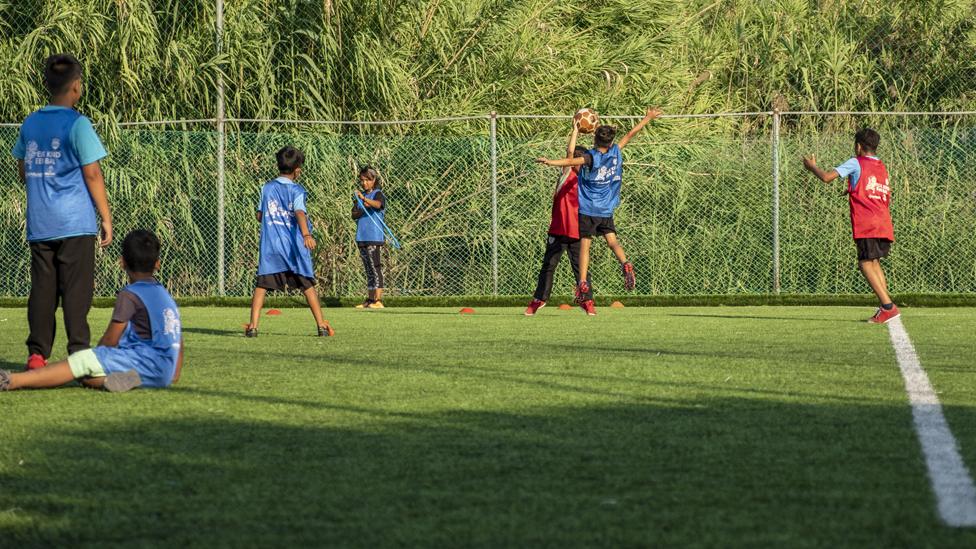 Young refugees playing football in Lesbos