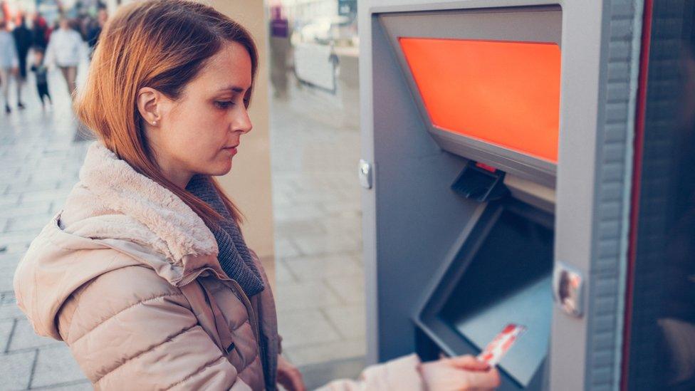 Woman using ATM