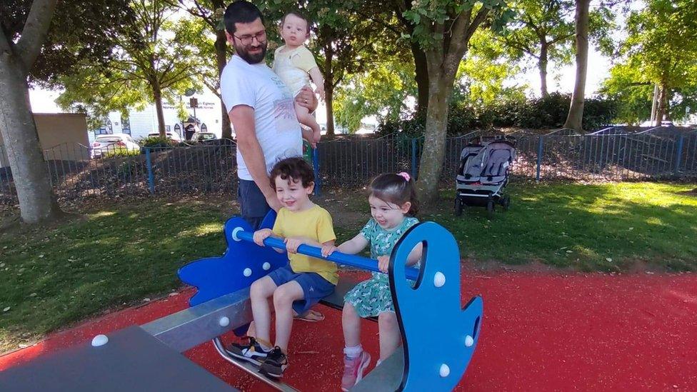 Grace, her father and siblings in a park