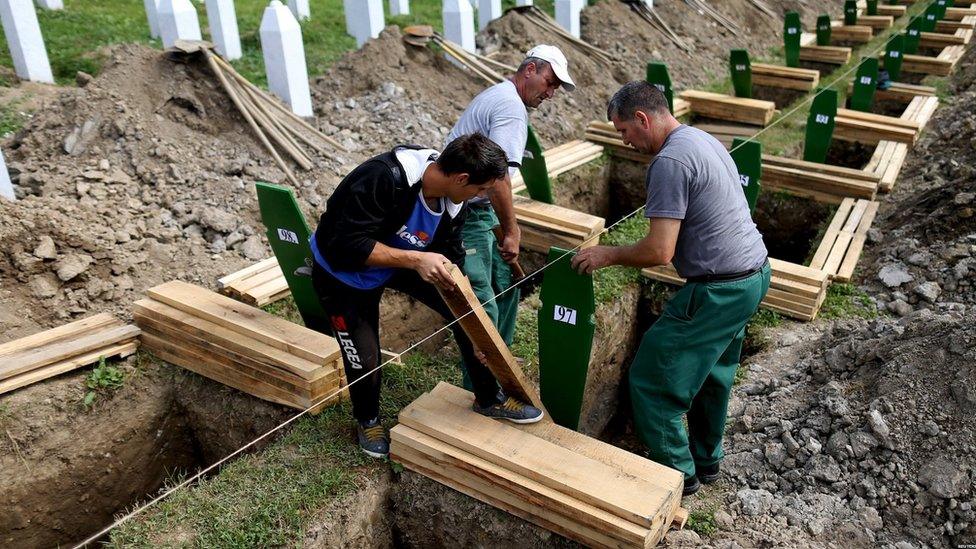 Workers prepare graves for burial in Potocari Cemetery on 10 July 2015