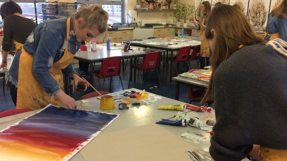 Pupils painting in an art class