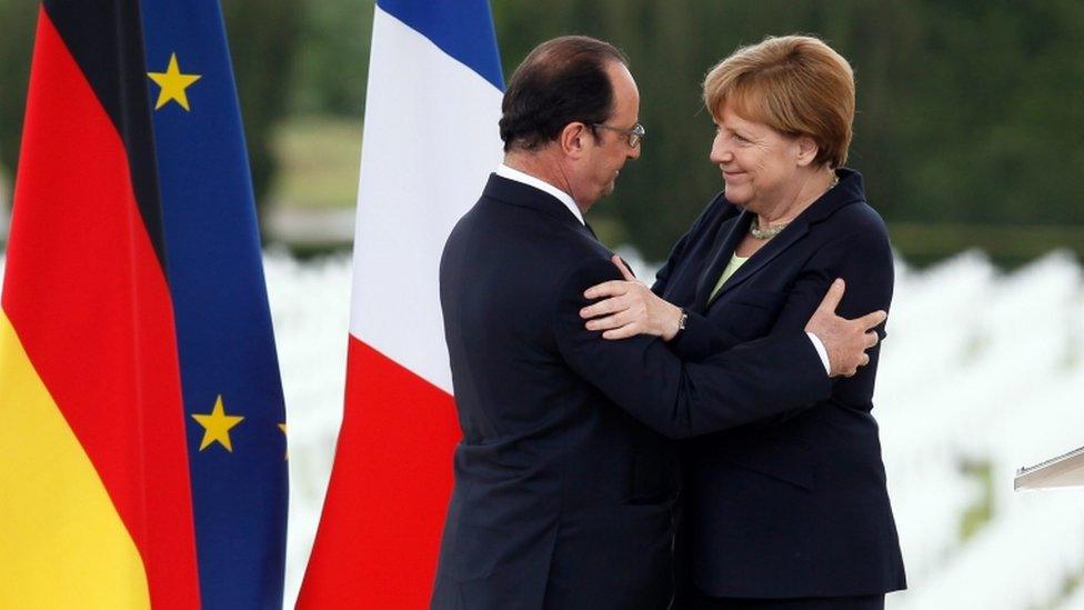 French President Francois Hollande (L) greets German Chancellor Angela Merkel (R) after delivering speeches to mark the centenary of the battle of Verdun