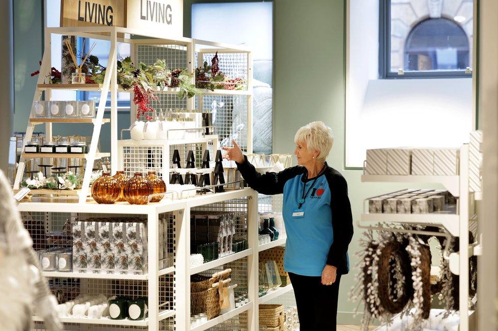 A Primark worker in the Bank Buildings shop adjusts a display