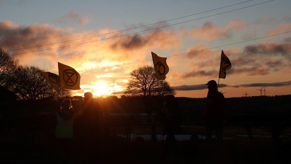 Protesters in front of sunrise