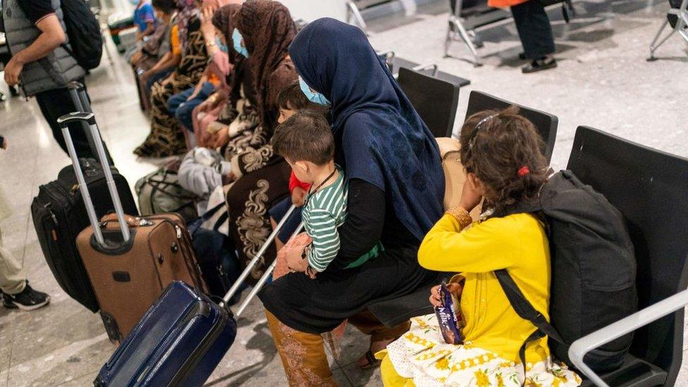 Afghan refugees waiting to be processed after arriving on an evacuation flight at Heathrow Airport