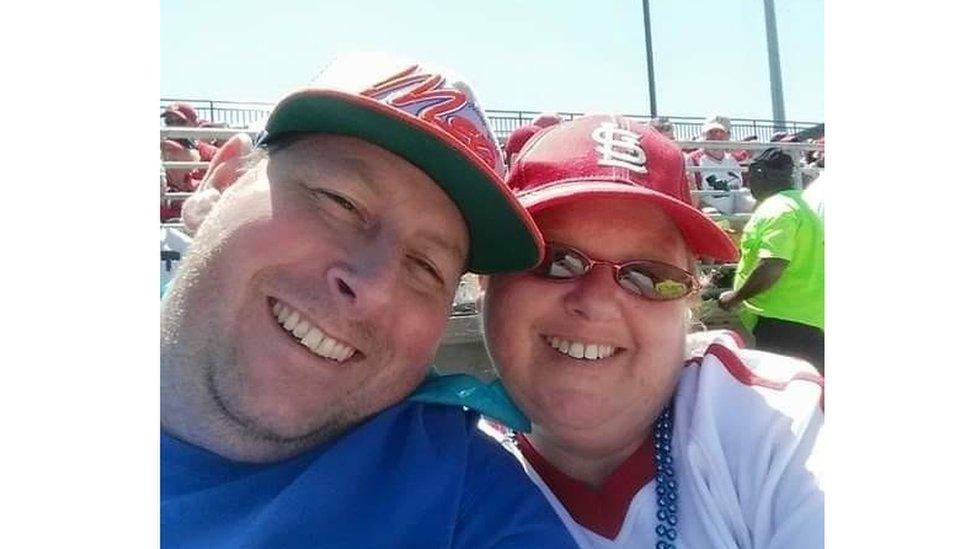 Man and woman at baseball game.