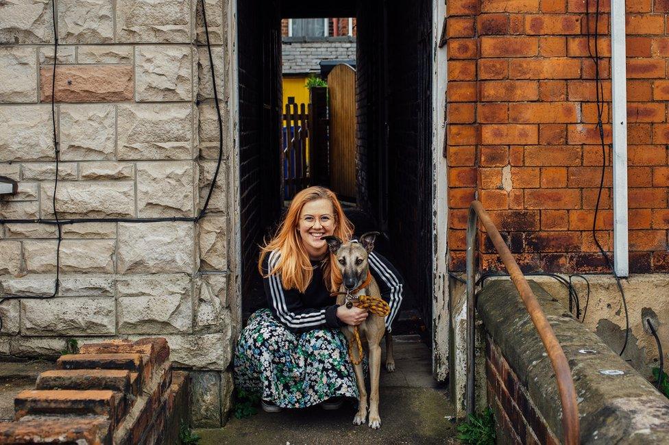 Doorstep portrait of photographer Ellie Last and her dog Luther