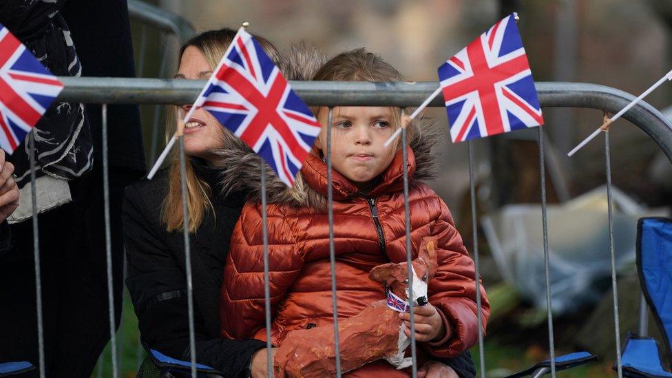 Members of the public line the streets in Ballater, Scotland, as the hearse carrying the coffin of Queen Elizabeth II, will pass through Ballater