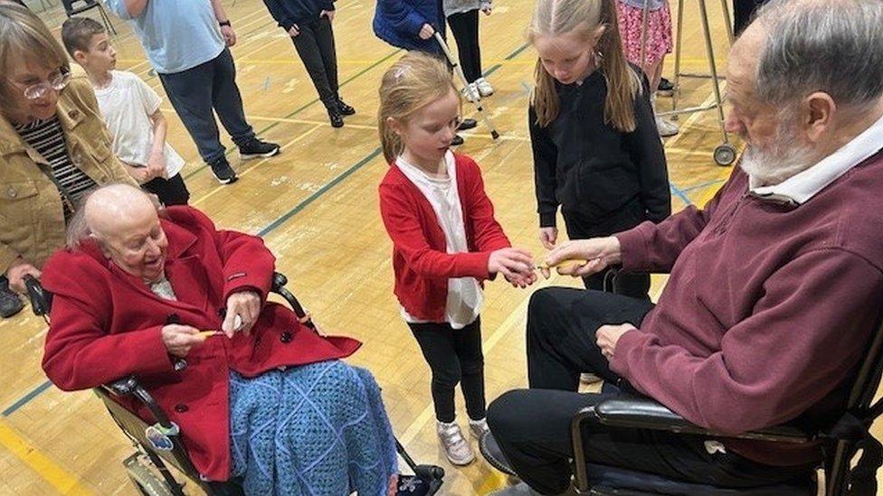 Care home residents meet with young children