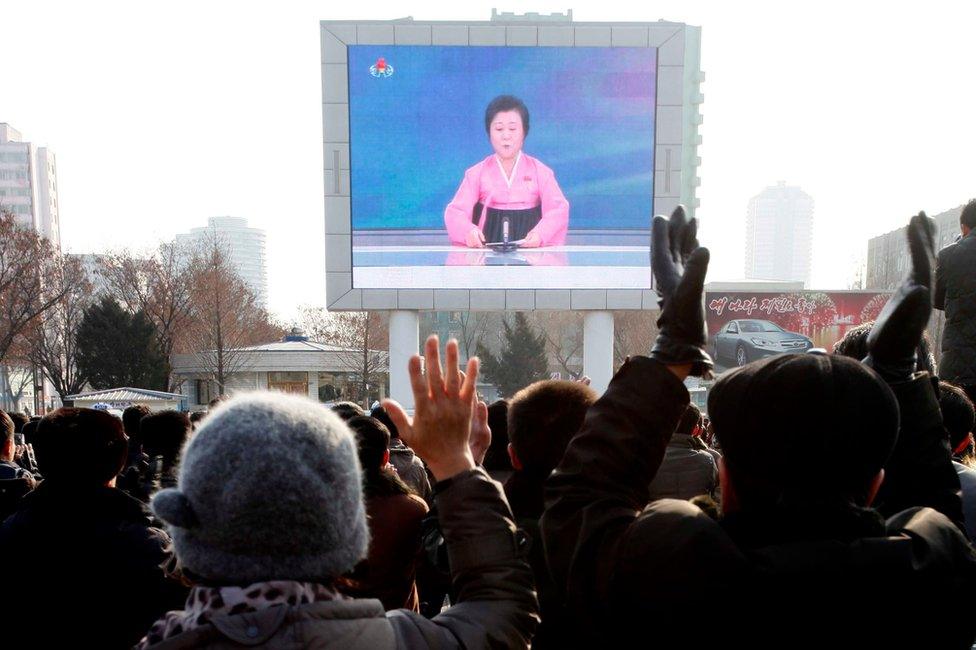 North Koreans watch a news broadcast about the test on a video screen outside Pyongyang Railway Station