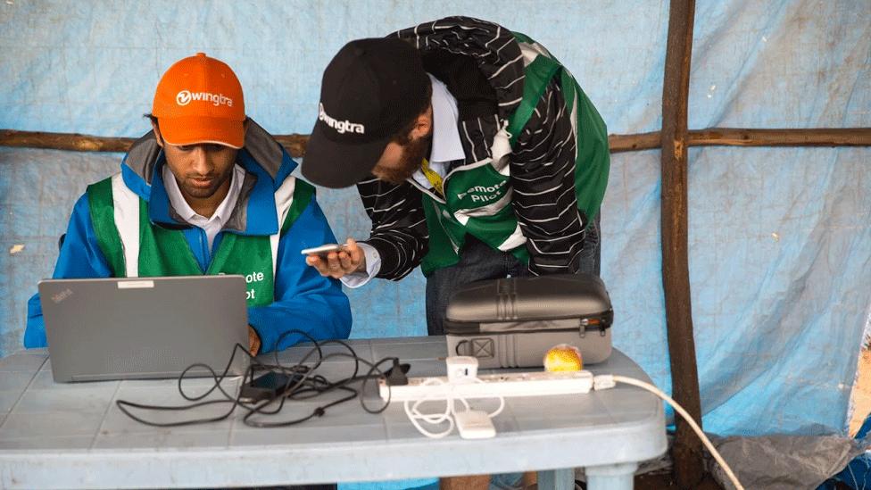 Engineers monitor the drone's progress