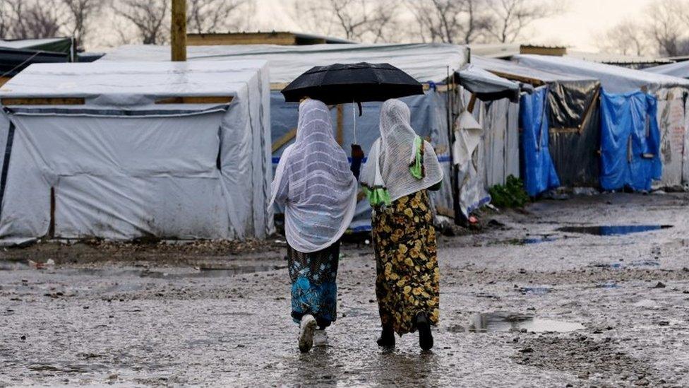 Women walking through the jungle camp in Calais (April 2016)