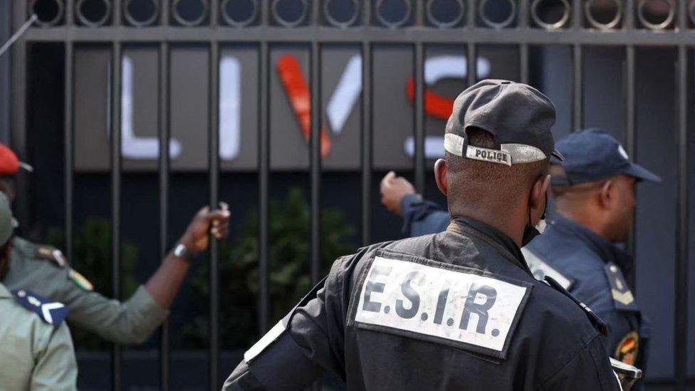 Police stand guard at the entrance of the Livs nightclub where a deadly fire occurred in the Bastos district of Yaounde, on January 23, 2022