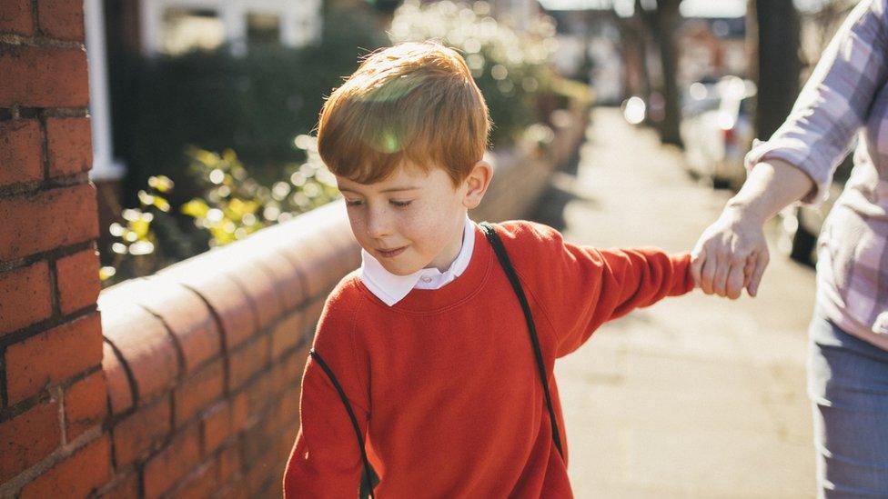 young-boy-pulling-parent