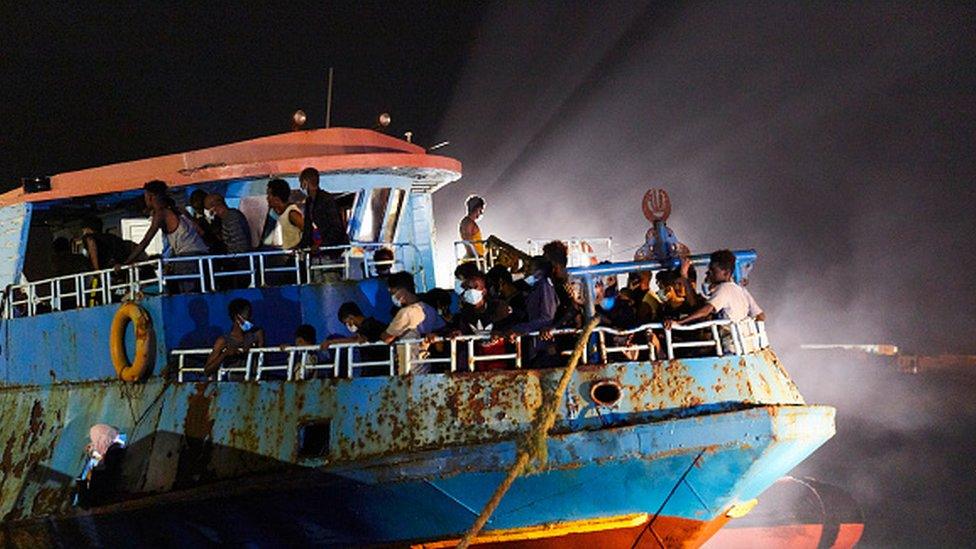 A large fishing ship coming from Libya is about to disembark migrants in Lampedusa, Italy.