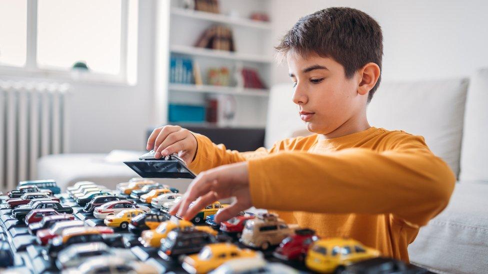 Boy with toy cars.