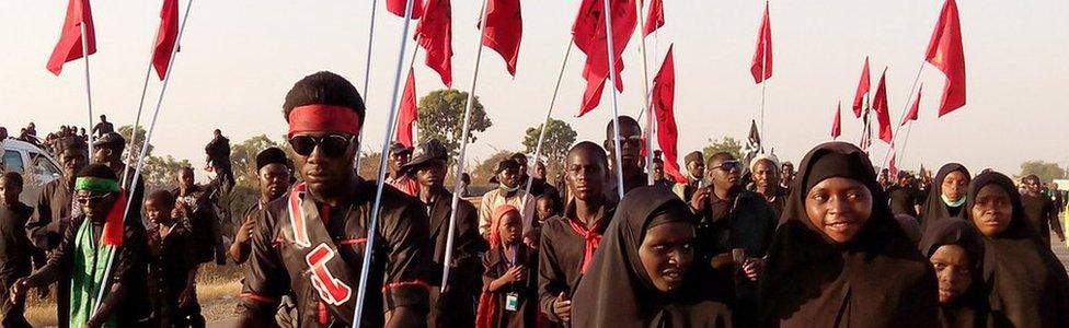 Shia Muslims march on the highway during a symbolic procession commemorating the 40th anniversary of the Ashura religious ceremony on 2 November 2015 in the village of Dakasoye, northern Nigeria