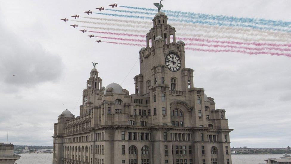 The RAF Red Arrows flying past the Liver building in Liverpool