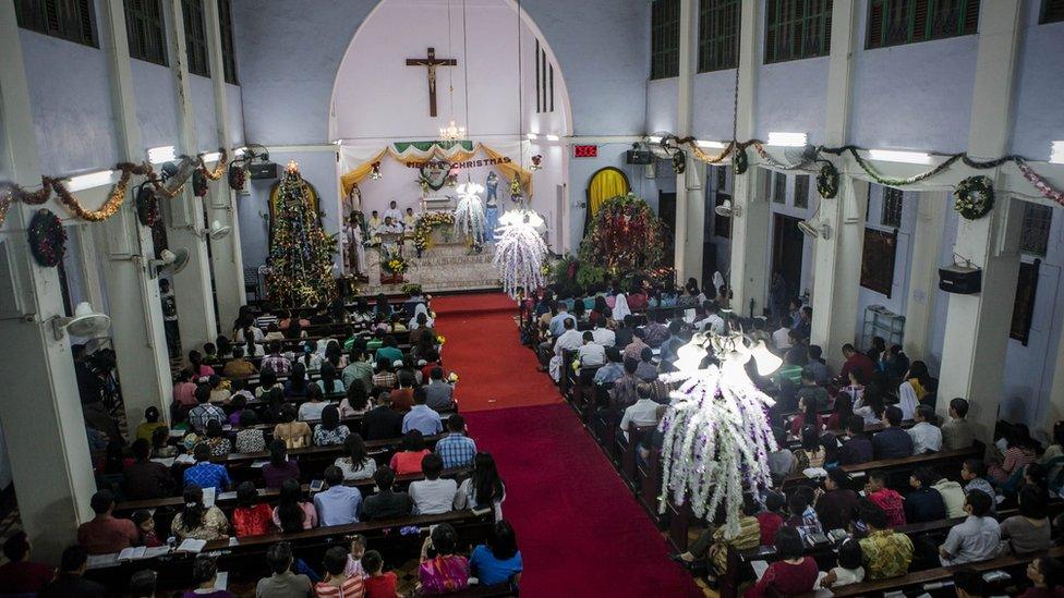 Christian worshipers attend Christmas Eve mass at Hati Kudus church on 24 December 2014 in Banda Aceh