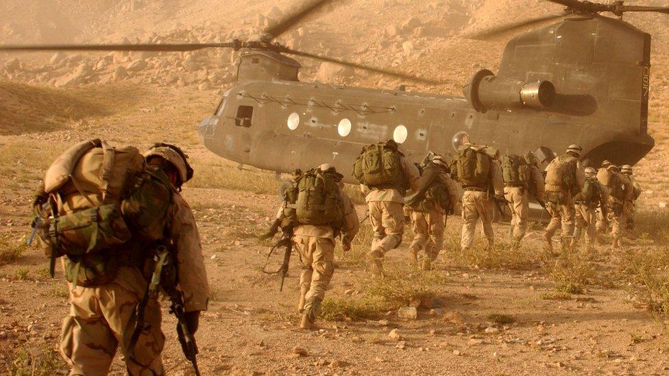 Soldiers board a Chinook helicopter in the invasion of Afghanistan 2001.