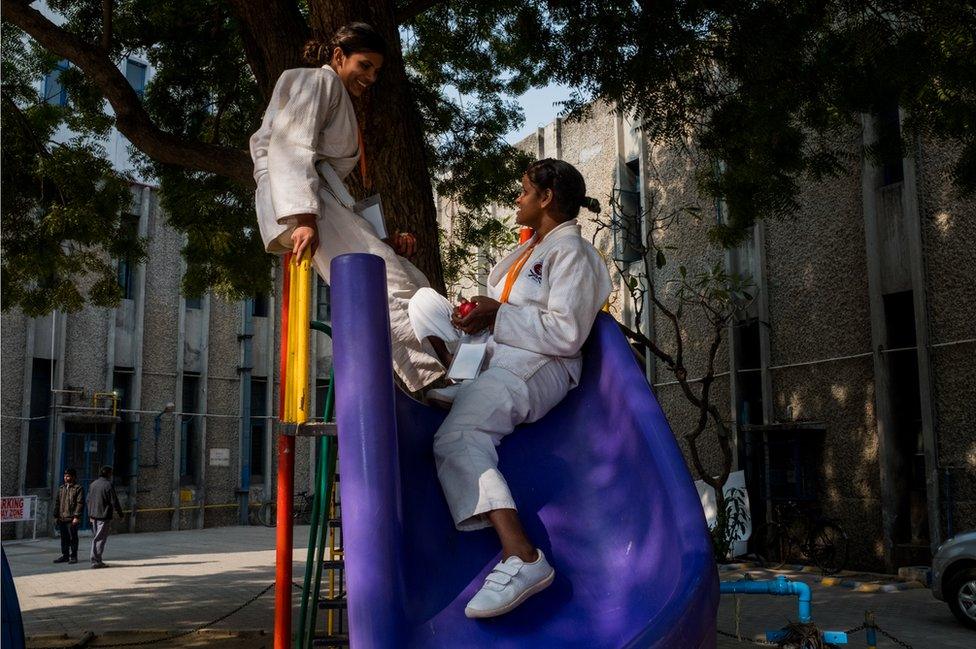 Two women talk on a slide