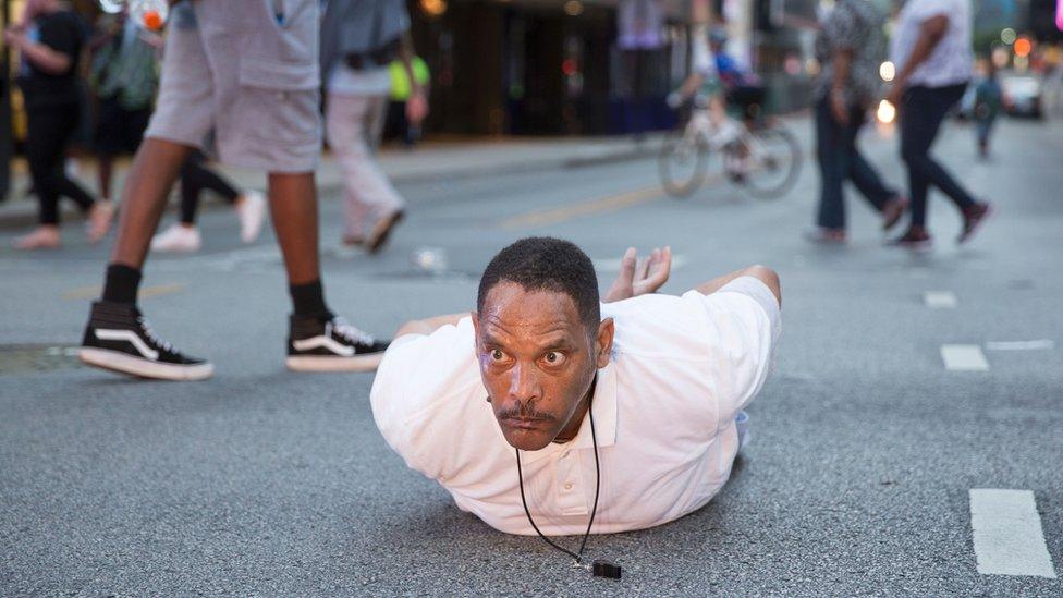 A man lays on the ground after yelling 'Don't shoot me' at police during a rally in Dallas, Texas - 7 July 2016