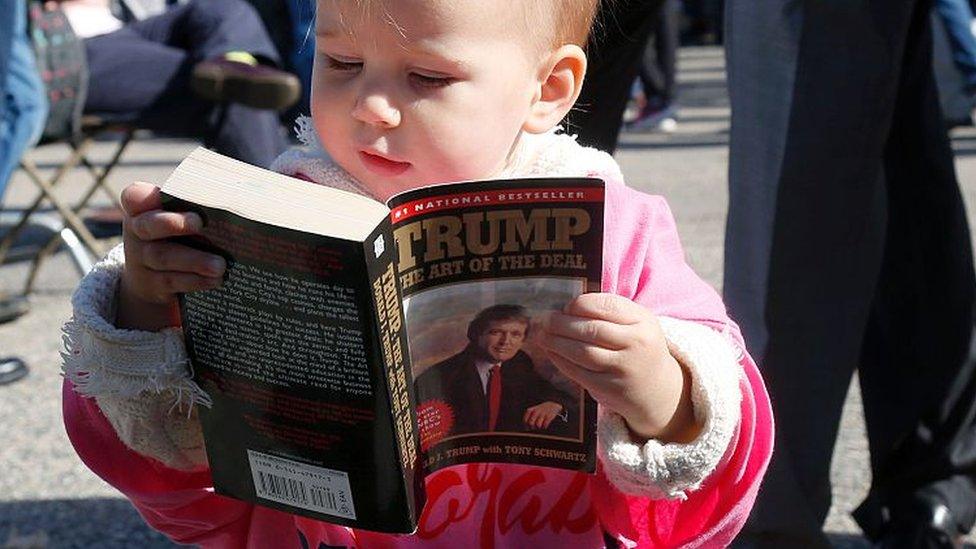 A child reads The Art of the Deal