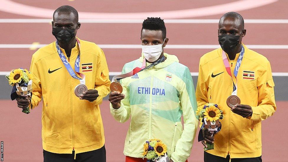 Joshua Cheptegei (left), Jacob Kiplimo (right) and Selemon Barega (centre) on the 10,000m podium at the Tokyo Olympics