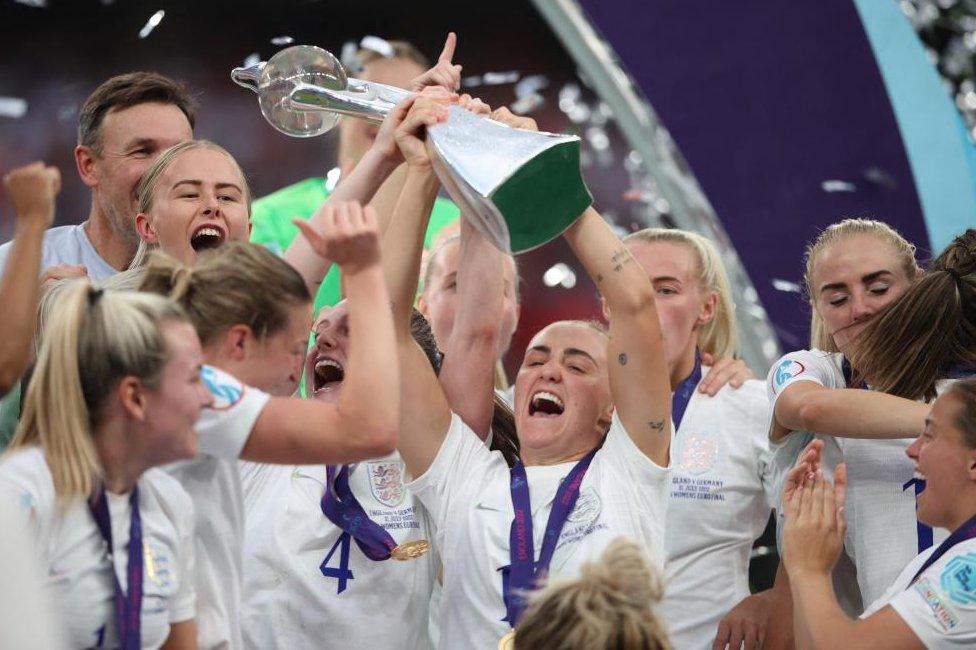 The England Lionesses celebrating winning Euro 2022 with the trophy