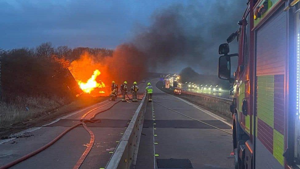 Fire crews fight a burning lorry