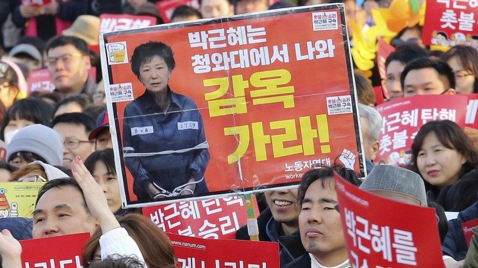 Anti-Park protesters in Seoul, 11 March. The sign reads Go to prison