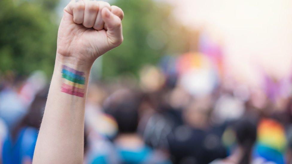 Picture of person with rainbow decoration on arm