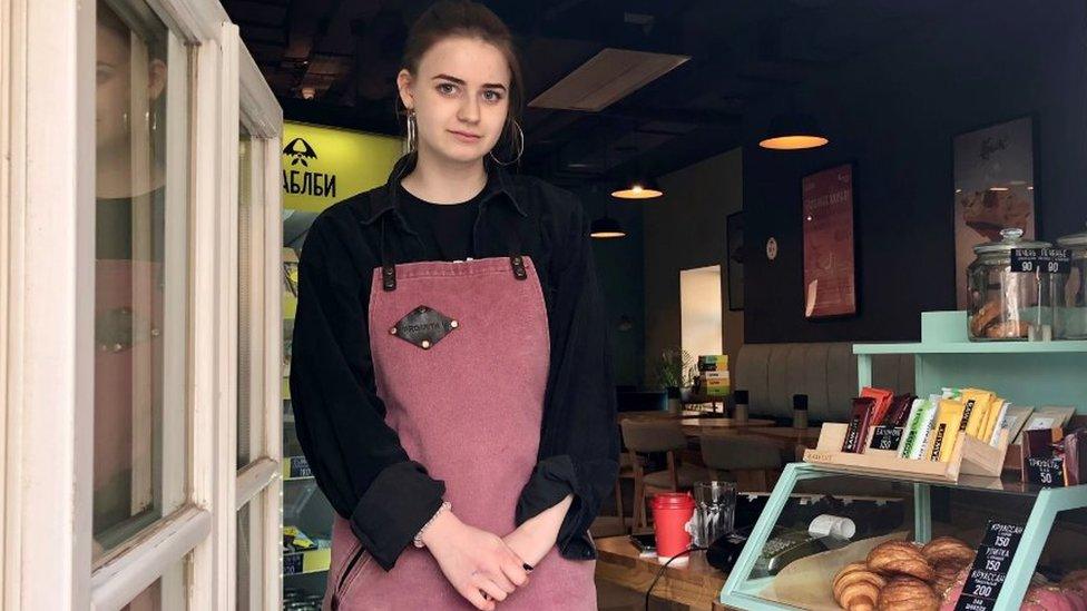 Barista sells fresh coffee from a window