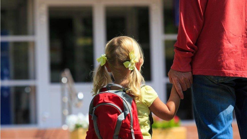 Parent taking child to school