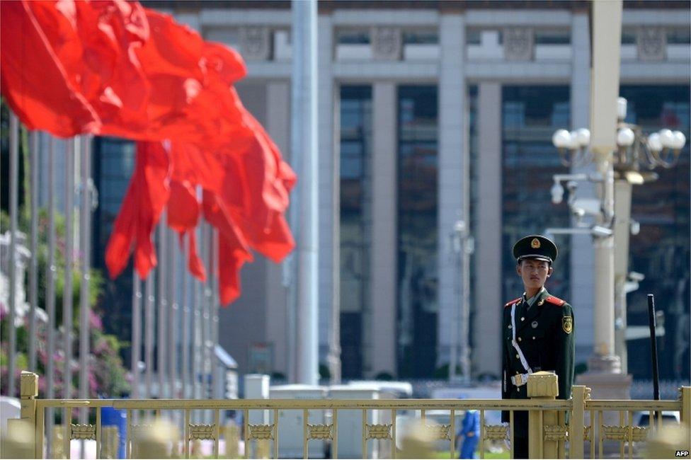 A paramilitary policeman stands at attention in Tiananmen Square in Beijing on 2 September 2015.