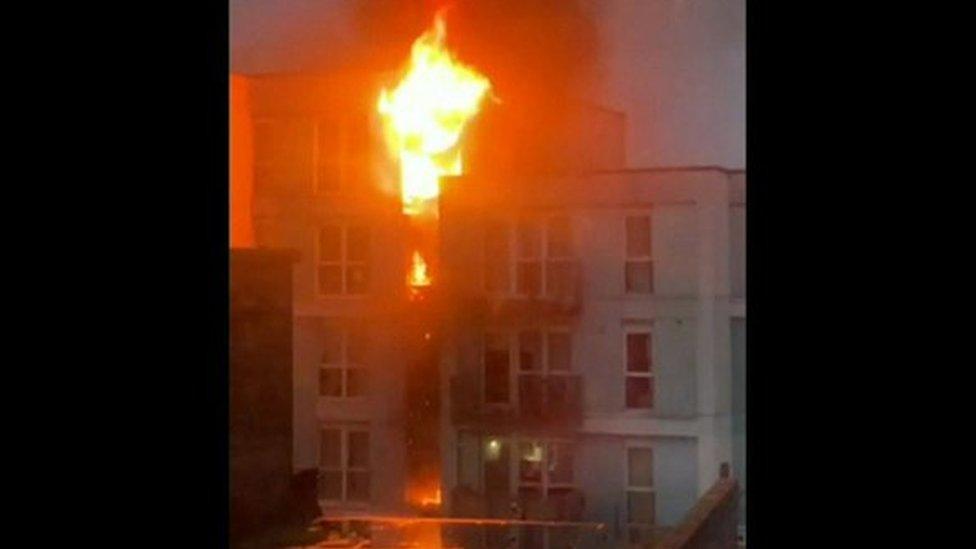 Large flames burn multiple flats in a building