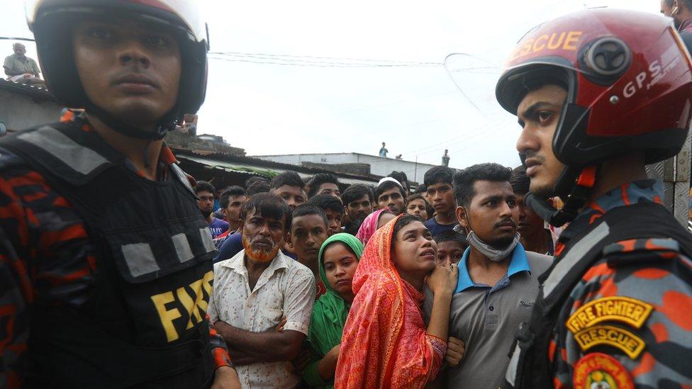 Crowds gather outside factory